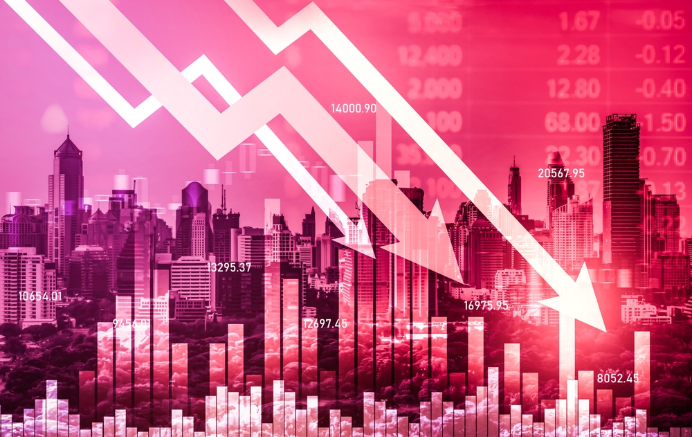 Illustration of a downward-trending line and arrow over a city skyline, indicating financial decline